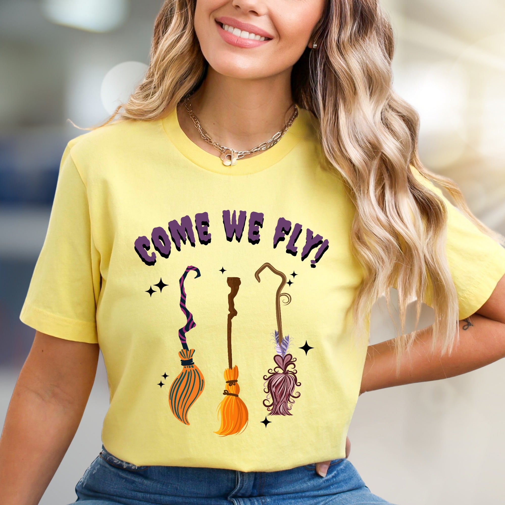 "COME WE FLY!" Witchy Broomstick Graphic Tee, a Spooky Chic Pick for Halloween Enthusiasts