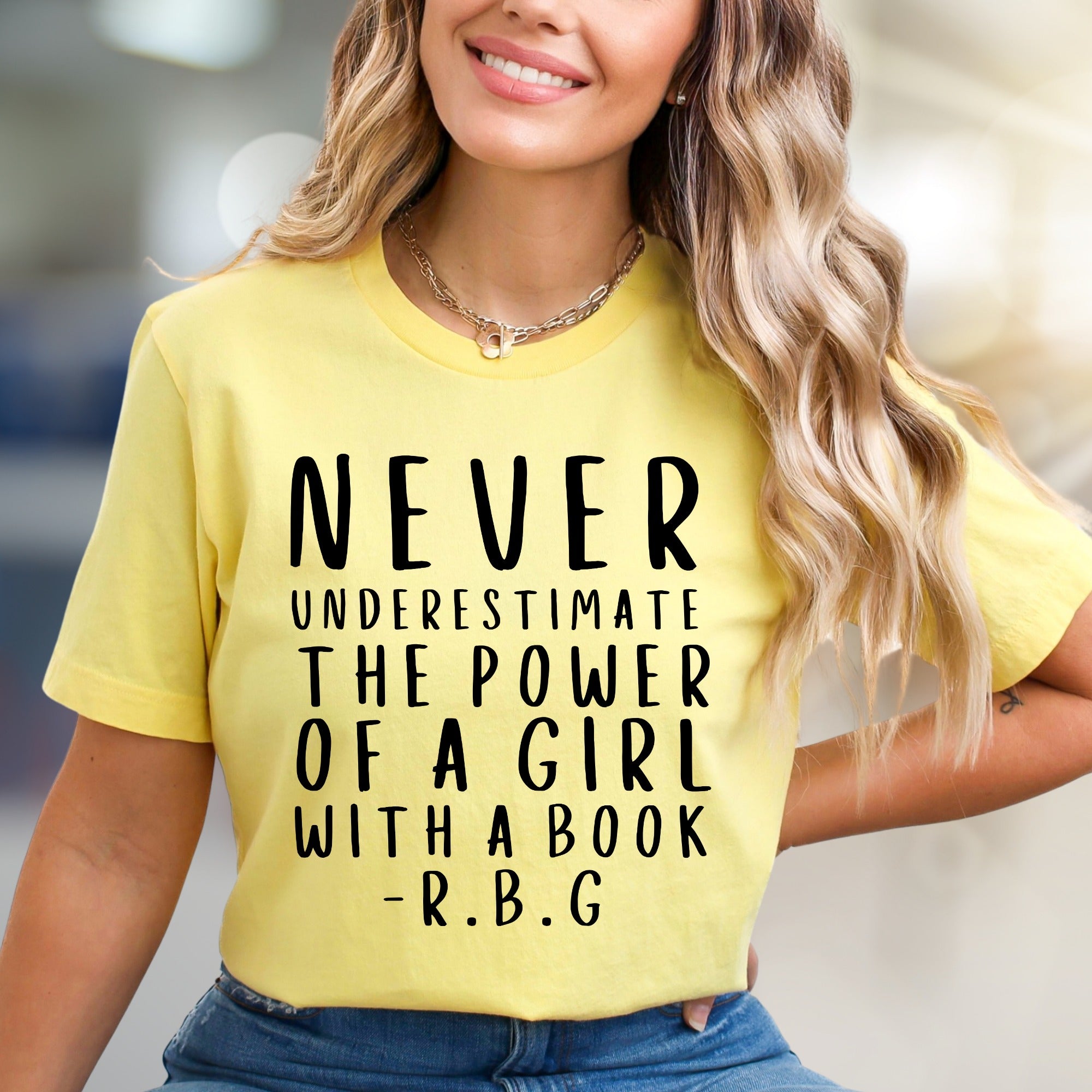 "NEVER UNDERESTIMATE THE POWER OF A GIRL WITH A BOOK -R.B.G" Empowerment Graphic Tee, a Feminist Pick for Readers