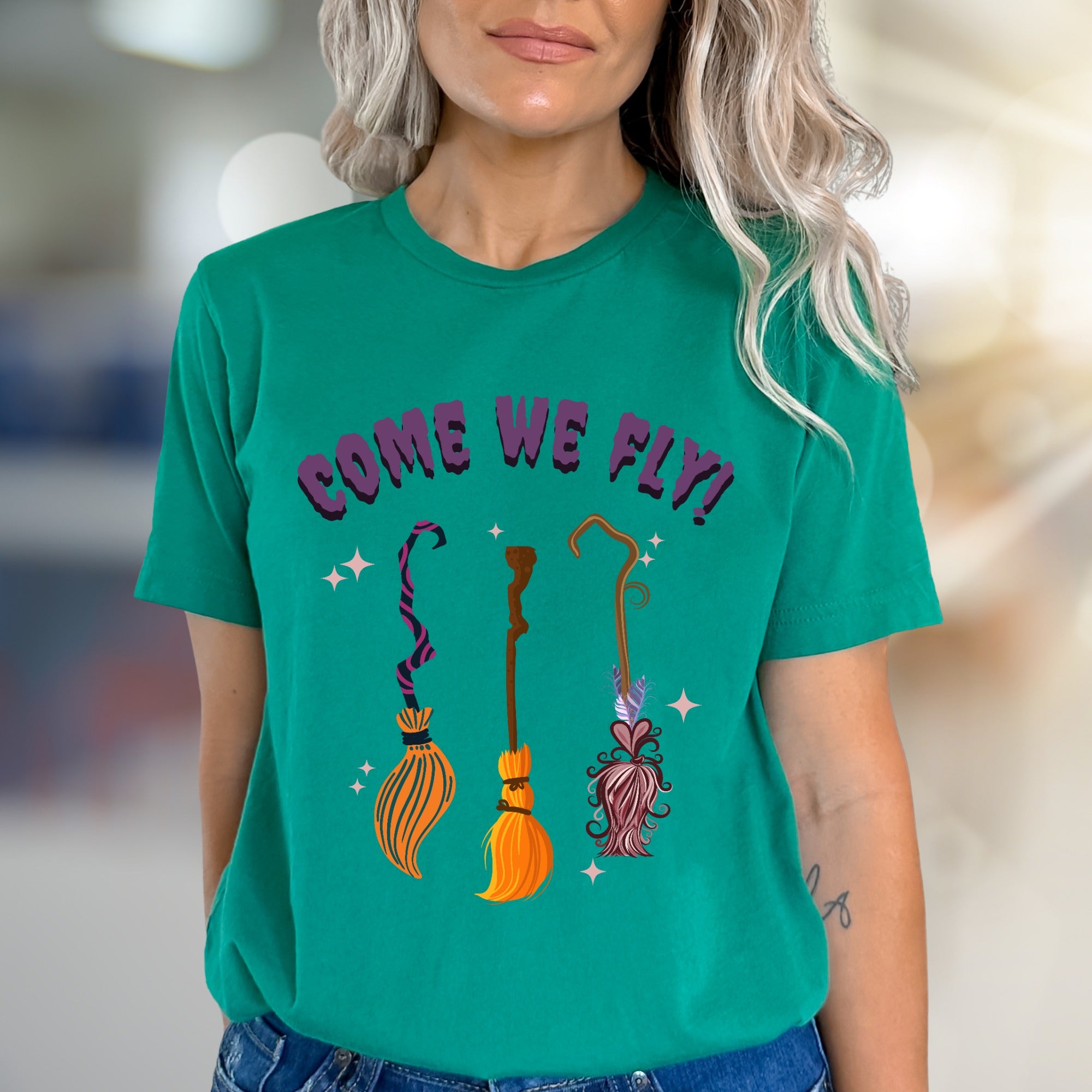 "COME WE FLY!" Witchy Broomstick Graphic Tee, a Spooky Chic Pick for Halloween Enthusiasts