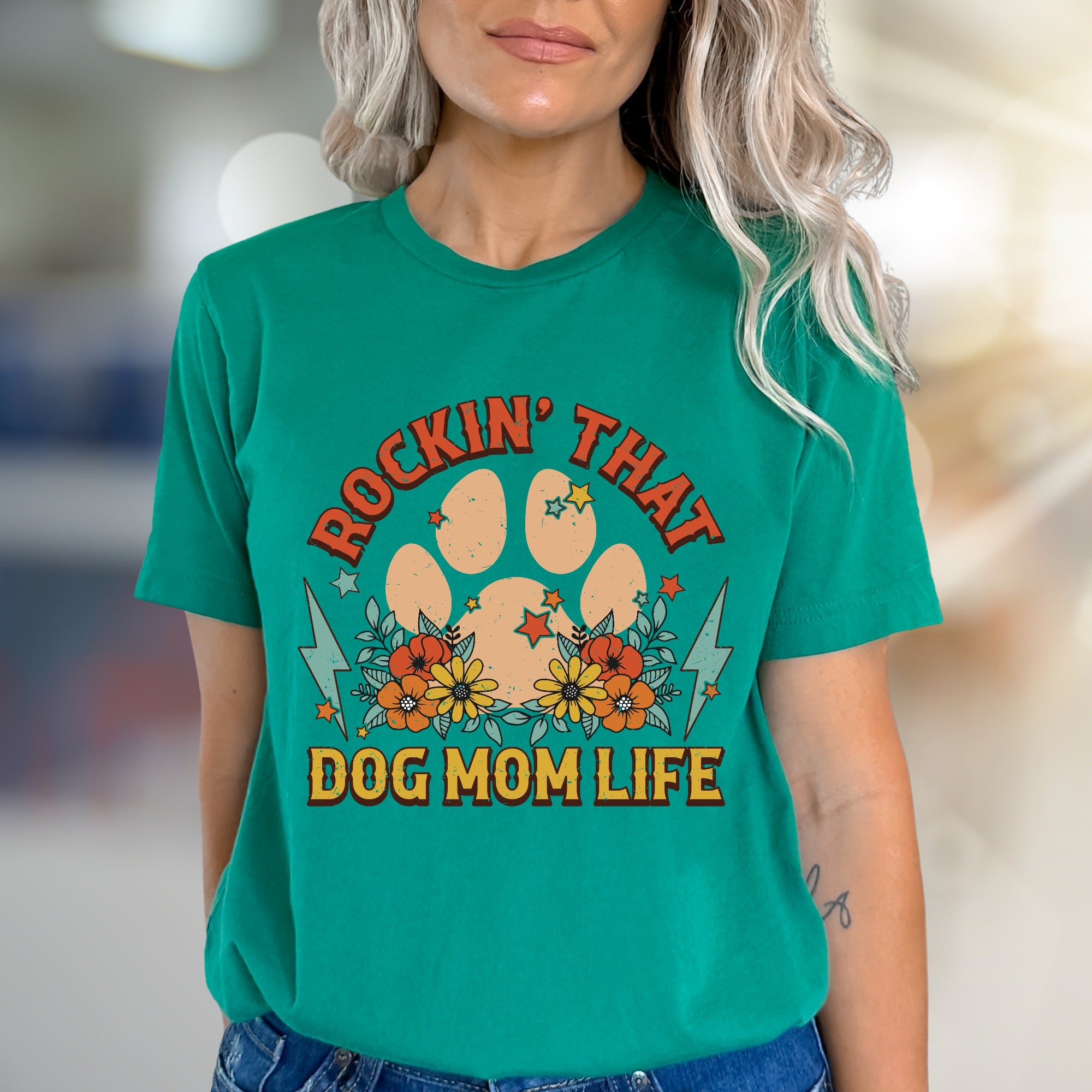 "ROCKIN' THAT DOG MOM LIFE" Retro Paw Print Graphic Tee, a Boho Chic Pick for Dog Lovers