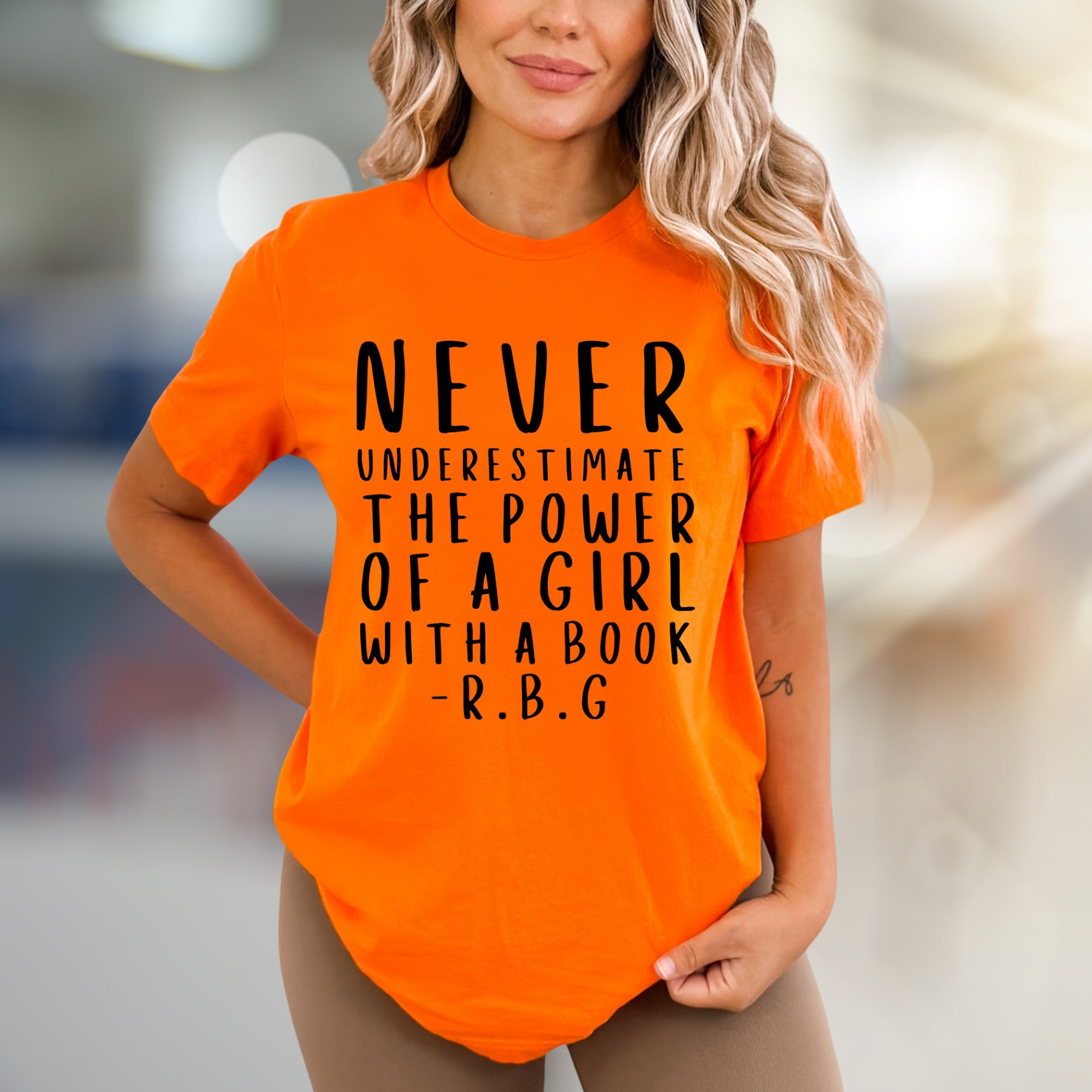 "NEVER UNDERESTIMATE THE POWER OF A GIRL WITH A BOOK -R.B.G" Empowerment Graphic Tee, a Feminist Pick for Readers
