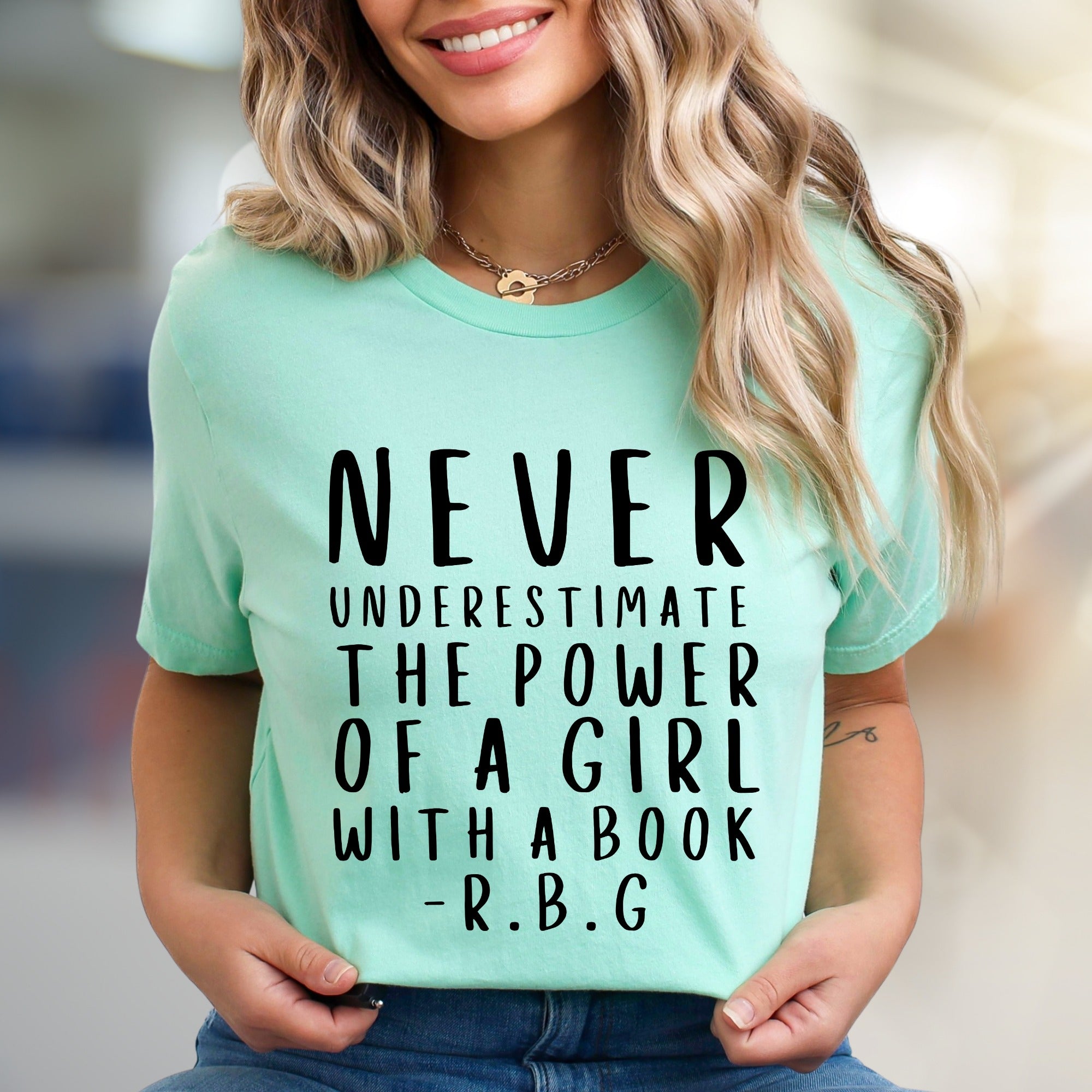 "NEVER UNDERESTIMATE THE POWER OF A GIRL WITH A BOOK -R.B.G" Empowerment Graphic Tee, a Feminist Pick for Readers