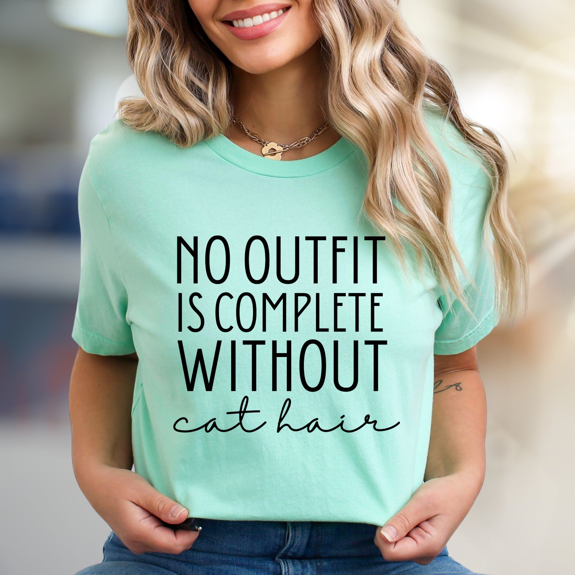 "NO OUTFIT IS COMPLETE WITHOUT cat hair" Humorous Cat Lover Graphic Tee, a Witty Lifestyle Pick for Pet Owners