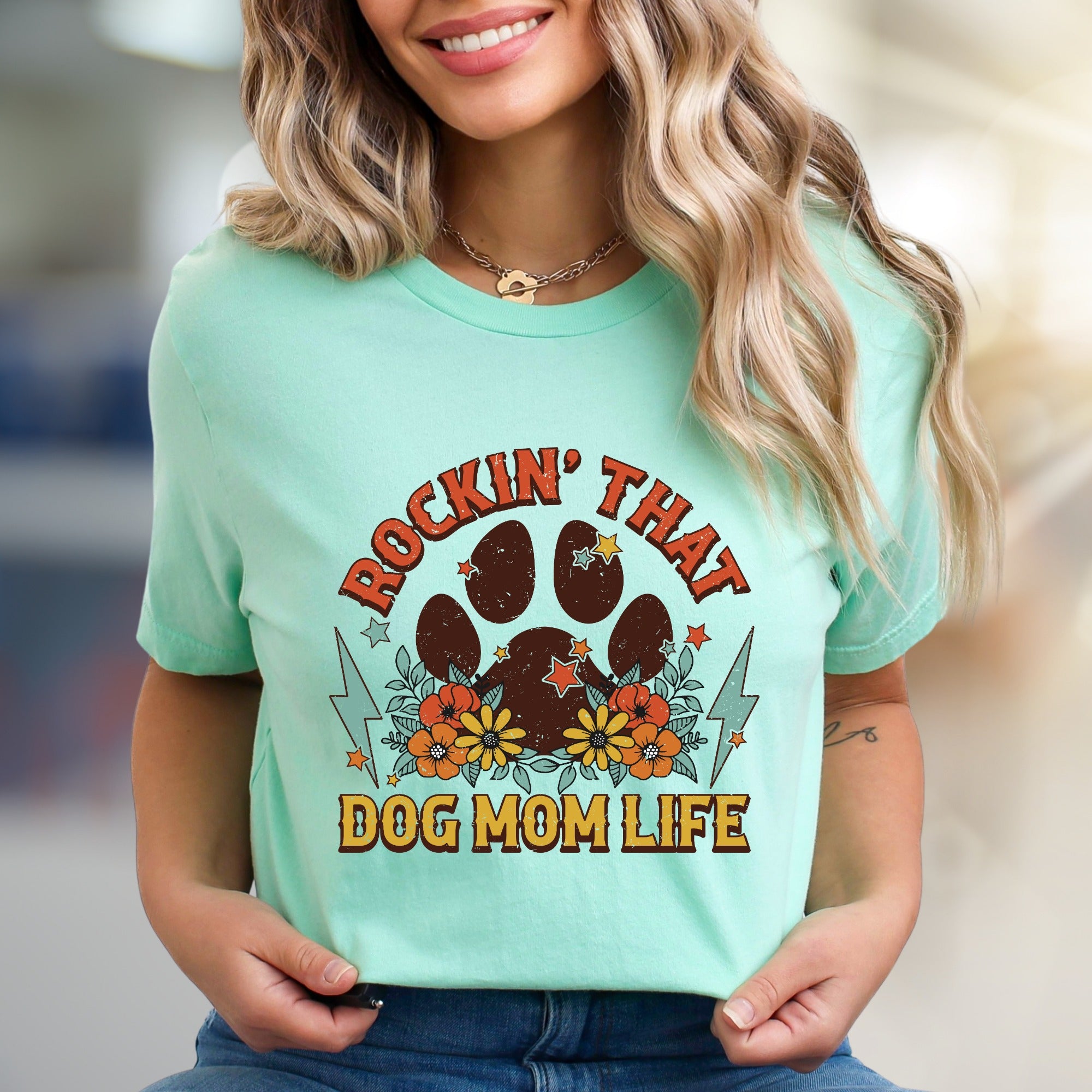 "ROCKIN' THAT DOG MOM LIFE" Retro Paw Print Graphic Tee, a Boho Chic Pick for Dog Lovers