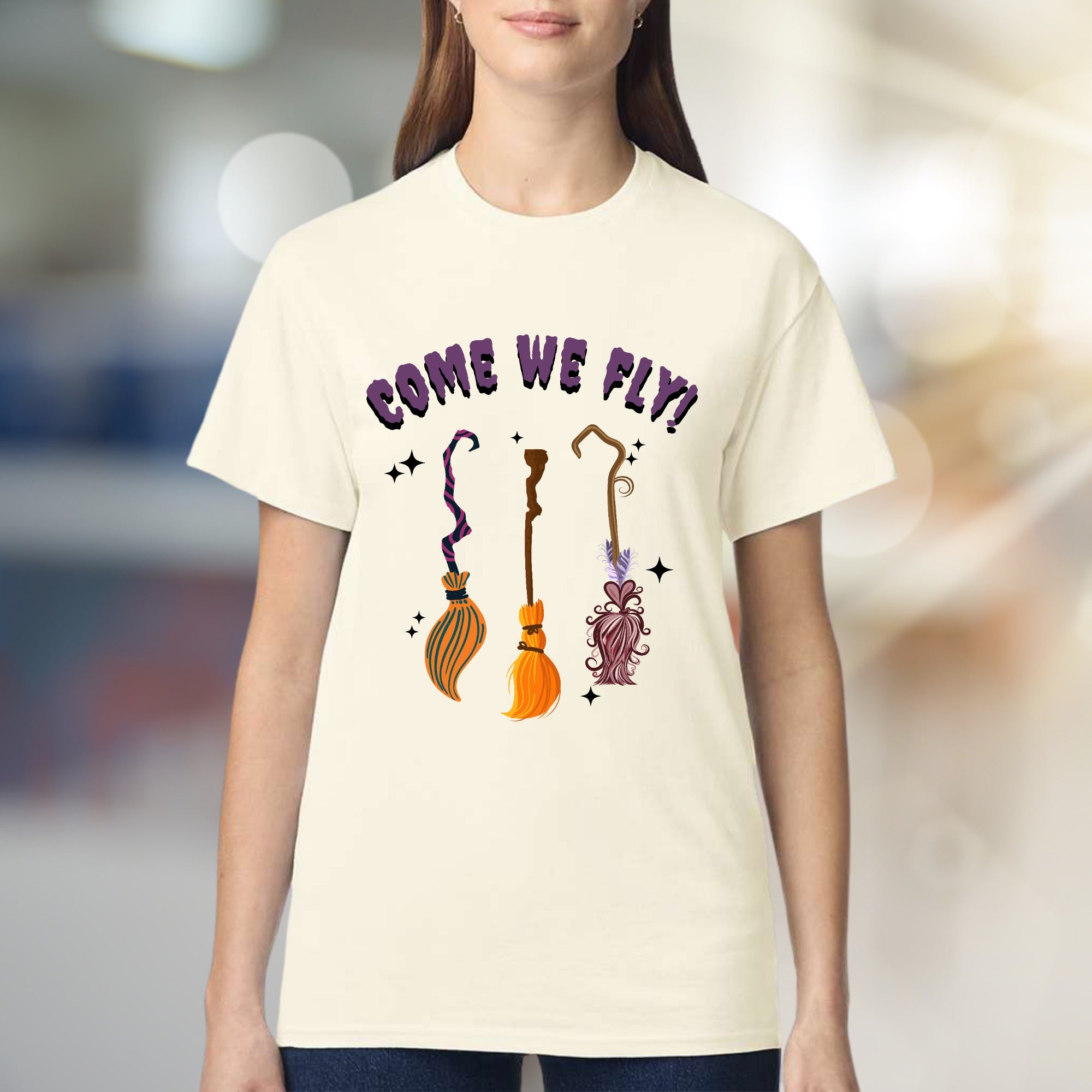 "COME WE FLY!" Witchy Broomstick Graphic Tee, a Spooky Chic Pick for Halloween Enthusiasts
