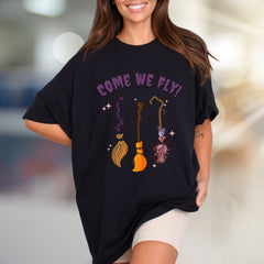 "COME WE FLY!" Witchy Broomstick Graphic Tee, a Spooky Chic Pick for Halloween Enthusiasts