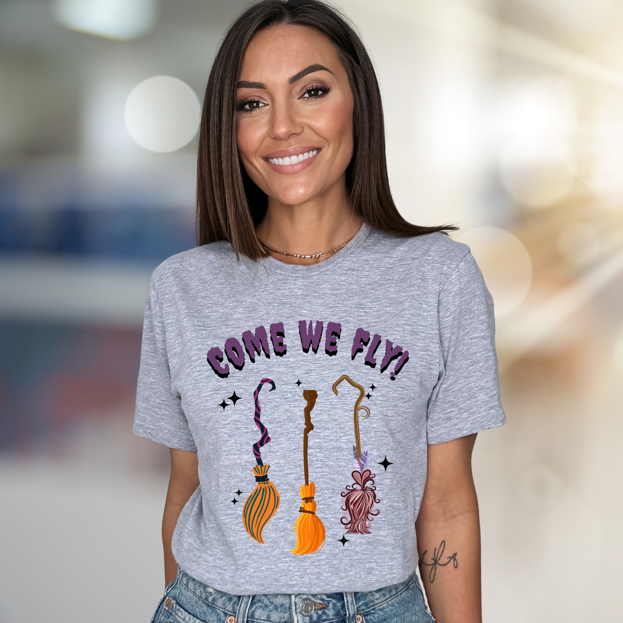 "COME WE FLY!" Witchy Broomstick Graphic Tee, a Spooky Chic Pick for Halloween Enthusiasts