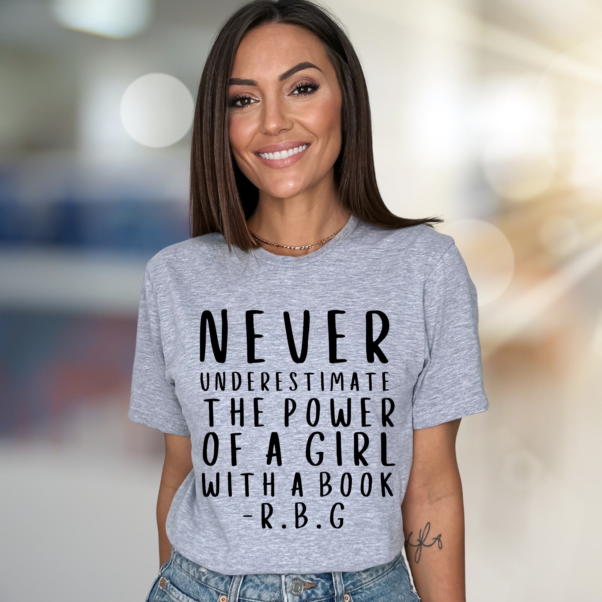 "NEVER UNDERESTIMATE THE POWER OF A GIRL WITH A BOOK -R.B.G" Empowerment Graphic Tee, a Feminist Pick for Readers