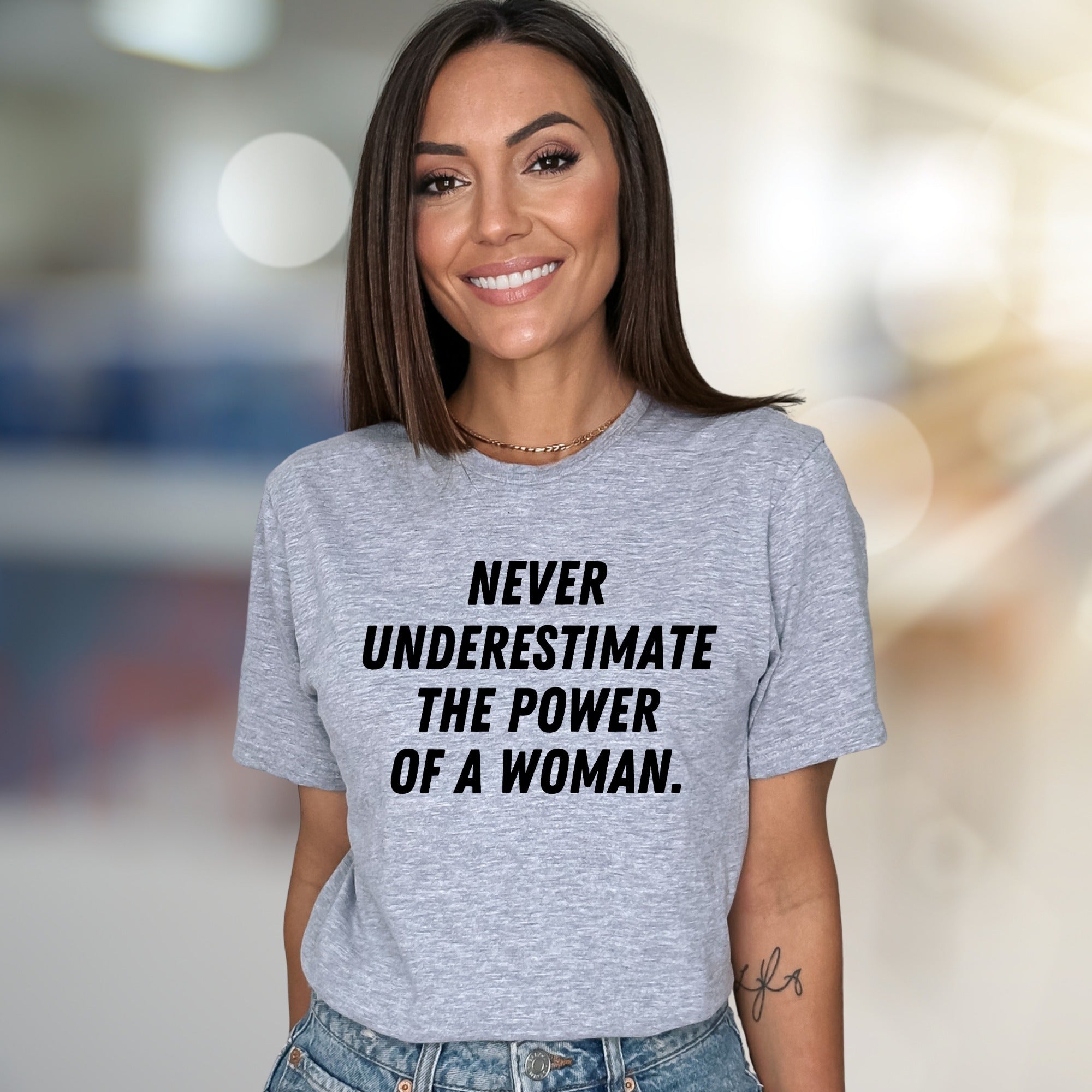 "NEVER UNDERESTIMATE THE POWER OF A WOMAN." Empowering Graphic Tee, a Bold Statement for Her