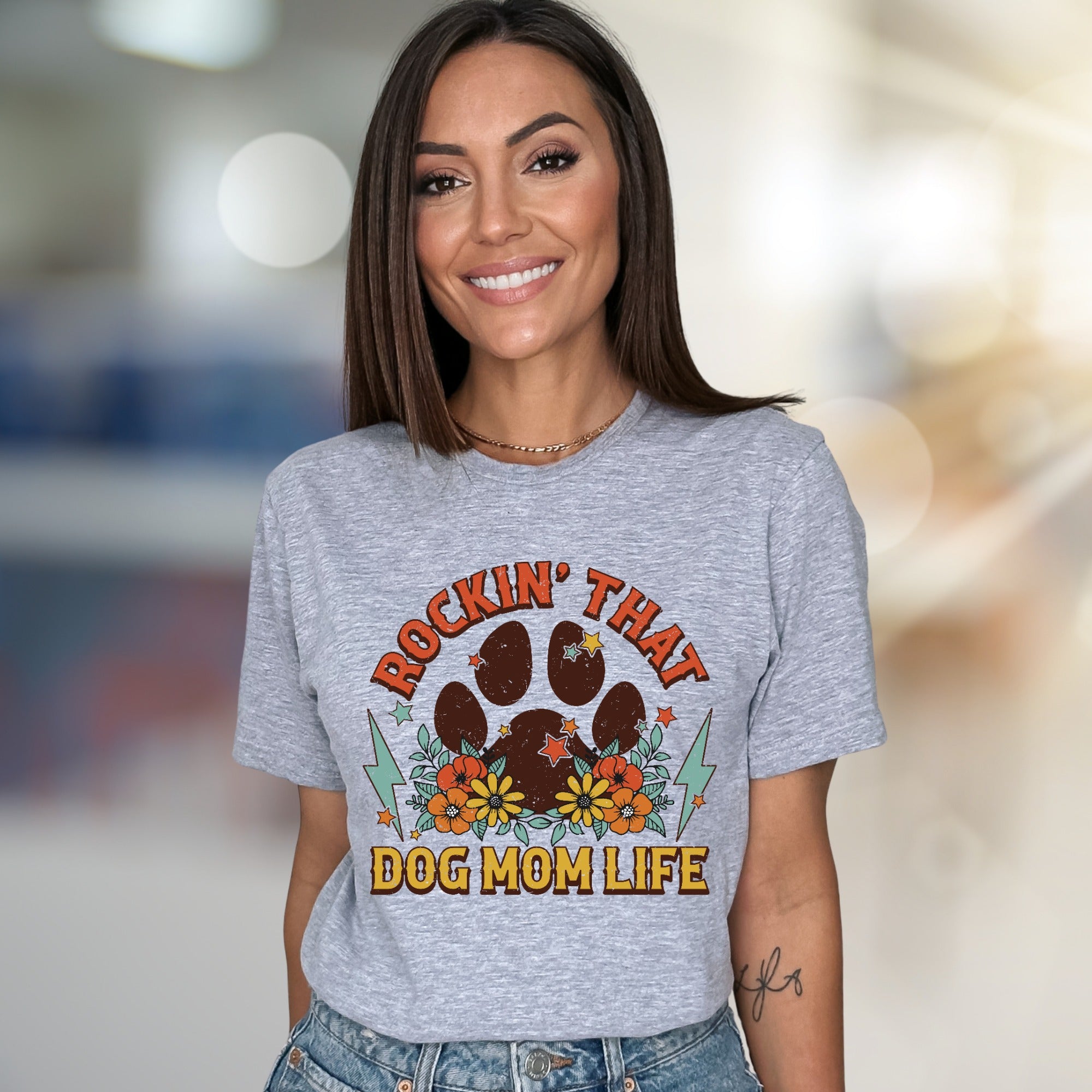 "ROCKIN' THAT DOG MOM LIFE" Retro Paw Print Graphic Tee, a Boho Chic Pick for Dog Lovers