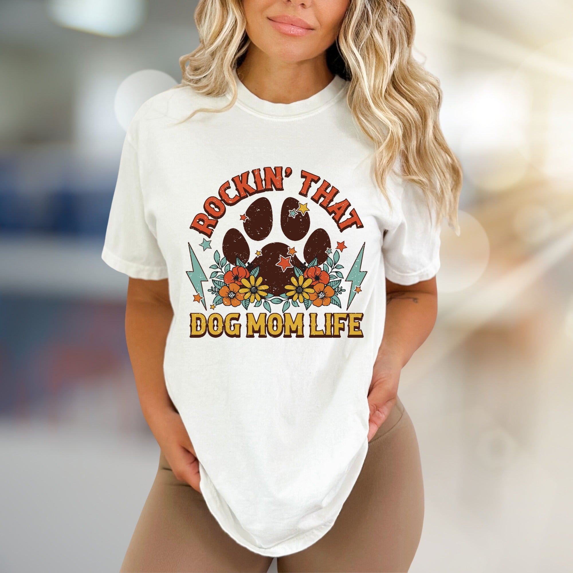 "ROCKIN' THAT DOG MOM LIFE" Retro Paw Print Graphic Tee, a Boho Chic Pick for Dog Lovers